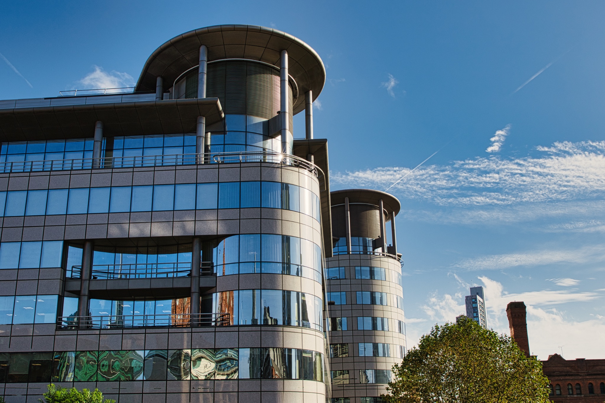 Curved Office Buildings with Blue Sky and Clouds in Manchester, UK.